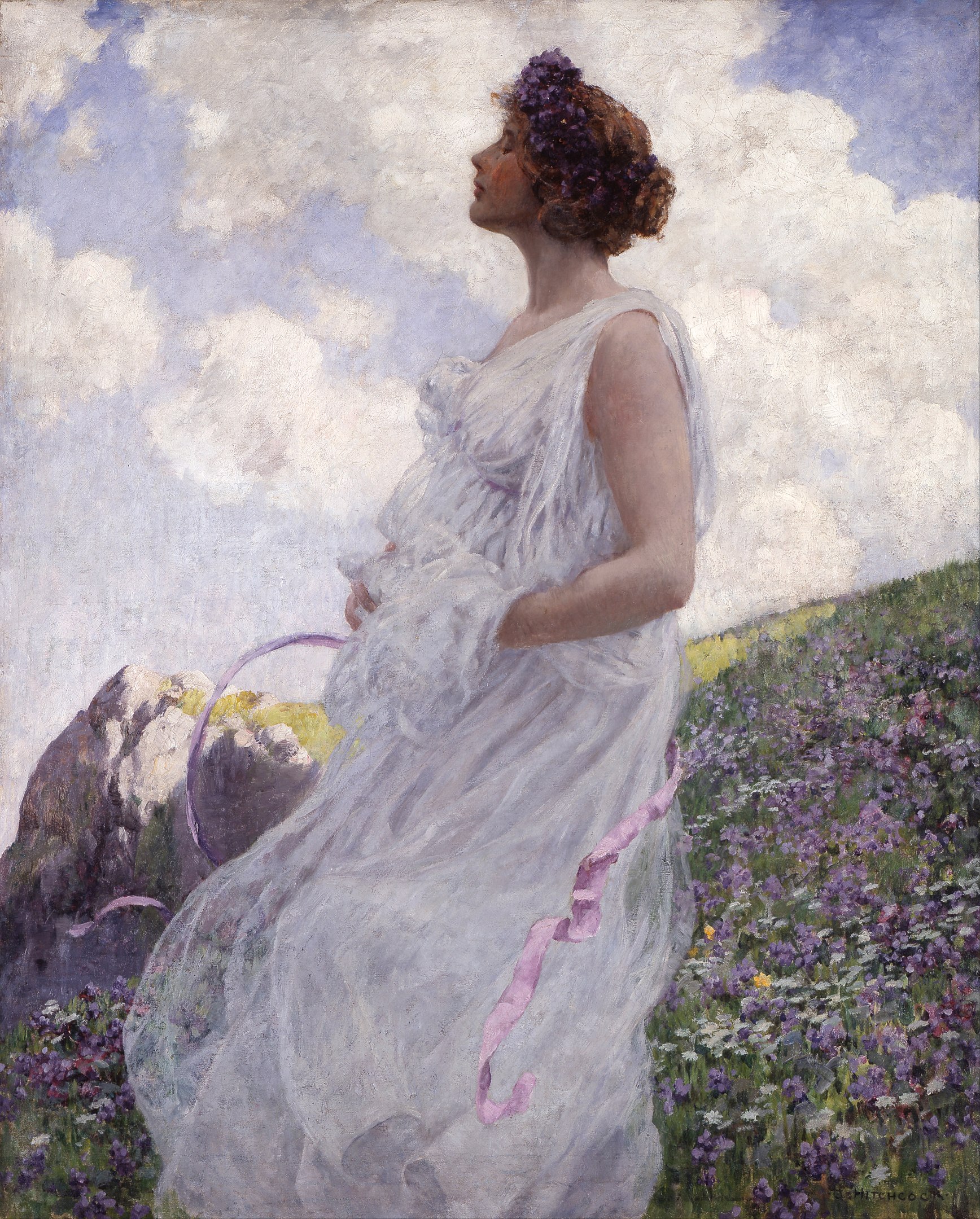 A woman in a meadow facing the sky with eyes closed