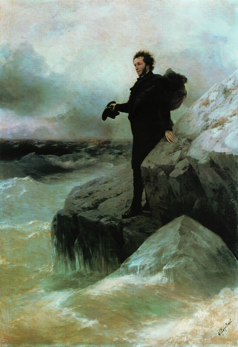 A man standing on the edge of a rock in the ocean with a storm brewing in the distance
