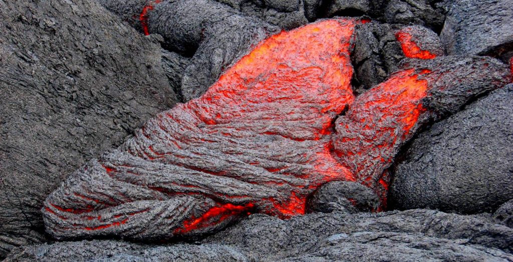 Red hto magma runs down rocks