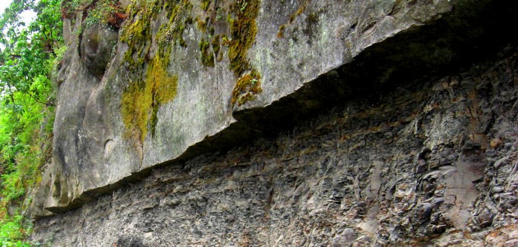 Marine sandstone sticks out over a wall of marine mudstone